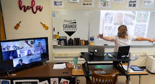 Caroline E. Schlegel, M. Ed., teaching Spanish remotely from her classroom to another classroom and an additional 5 students at home.